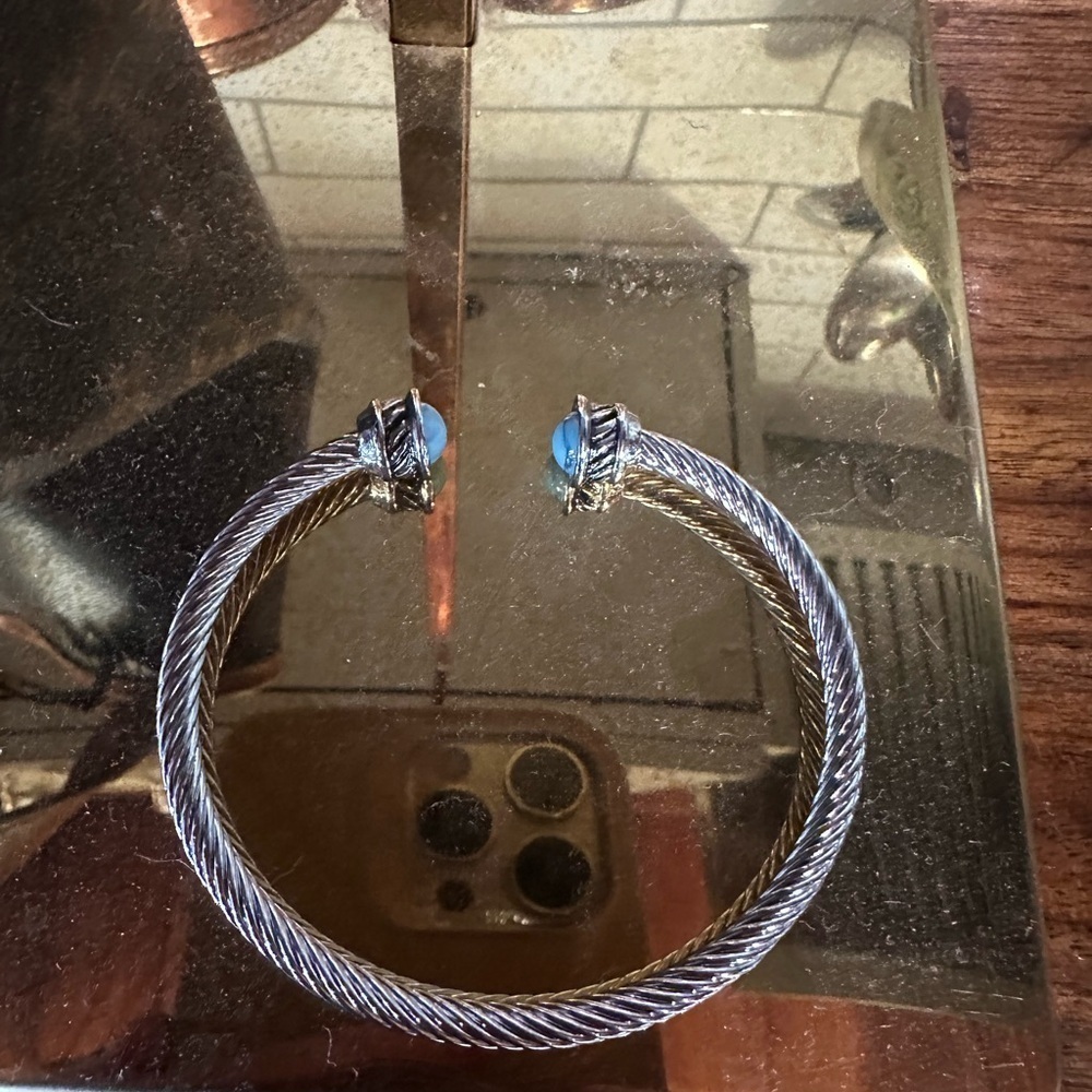Silver twisted bracelet with turquoise colored stone. Stainless steel
